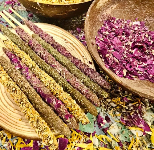 Artisan Dipped Palo Santo Ritual Sticks displayed with herbal ingredients and colorful floral petals for incense making.