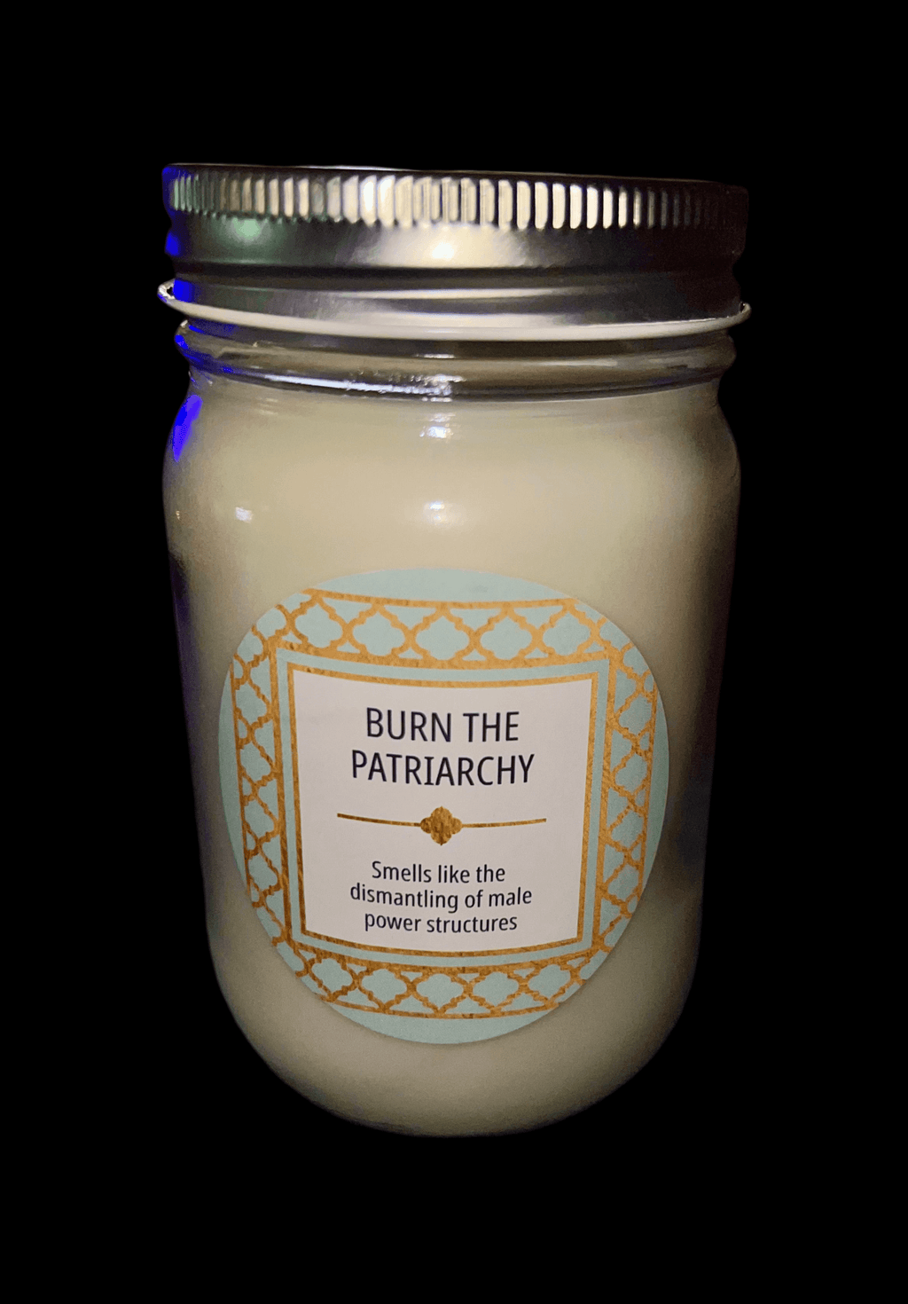 14 oz Burn the Patriarchy scented candle in a glass jar with a decorative label.